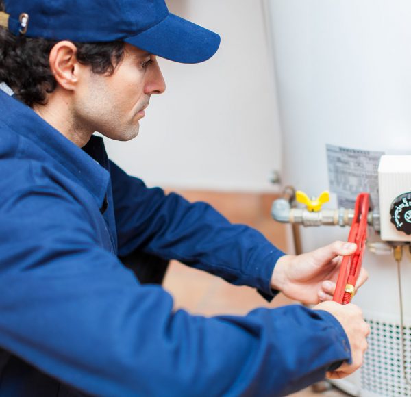 Plumber fixing an hot-water heater Plumber fixing an hot-water heater